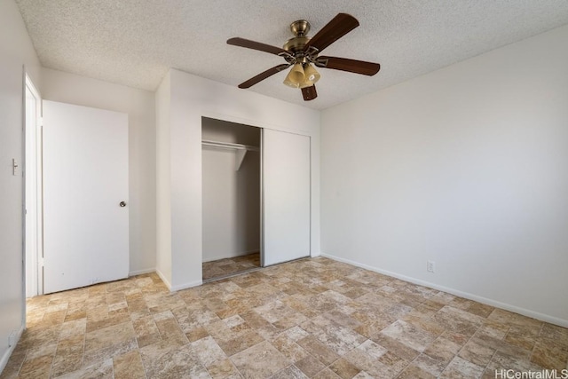 unfurnished bedroom with a closet, ceiling fan, and a textured ceiling