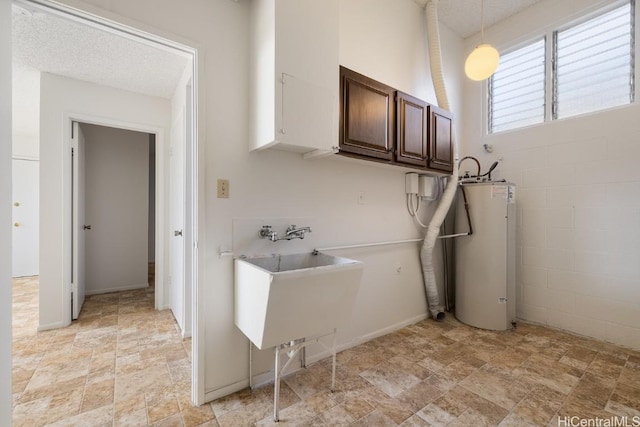 laundry room with cabinets, gas water heater, hookup for a washing machine, and sink