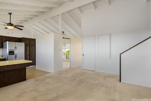 kitchen with stainless steel fridge with ice dispenser, ceiling fan, high vaulted ceiling, and beam ceiling