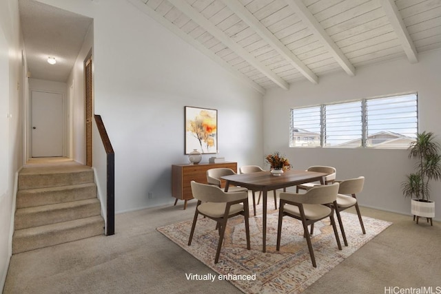 carpeted dining area featuring wood ceiling, high vaulted ceiling, and beam ceiling