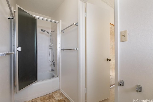 bathroom with shower / bath combination with glass door