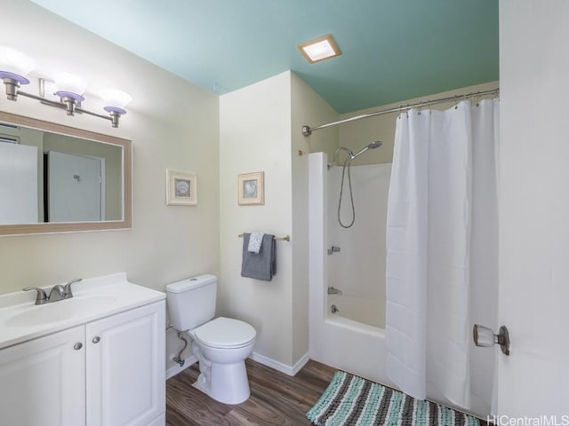 full bathroom with vanity, hardwood / wood-style floors, shower / tub combo, and toilet