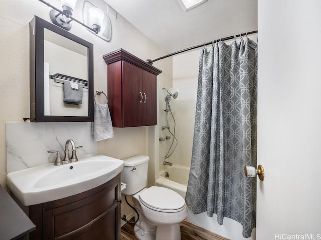 full bathroom featuring shower / bathtub combination with curtain, vanity, hardwood / wood-style flooring, and toilet