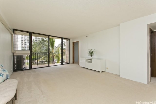 unfurnished living room with floor to ceiling windows, plenty of natural light, and light colored carpet