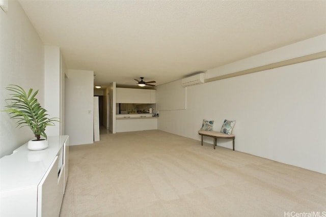 interior space with an AC wall unit, light carpet, and ceiling fan