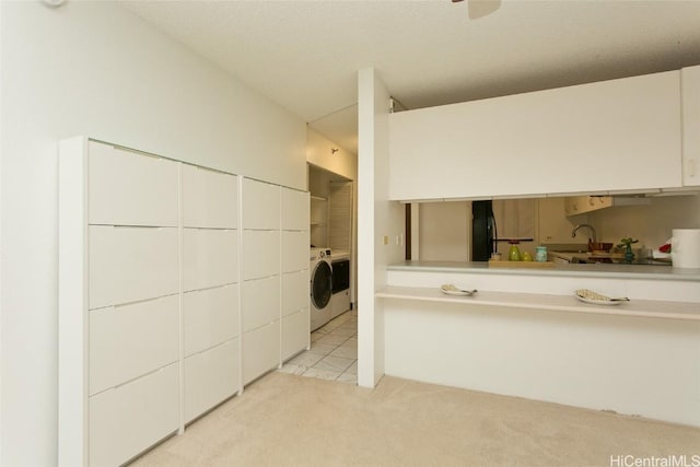 bathroom with sink and washing machine and clothes dryer