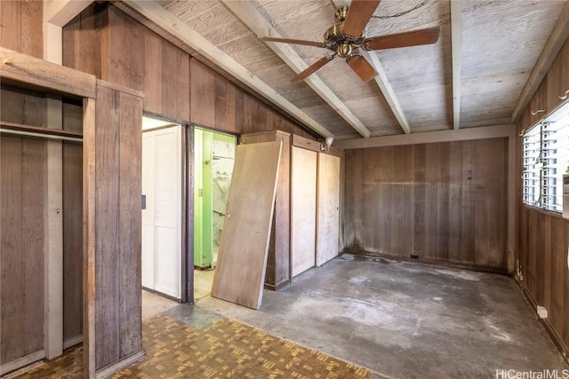 miscellaneous room featuring ceiling fan, lofted ceiling, and wooden walls