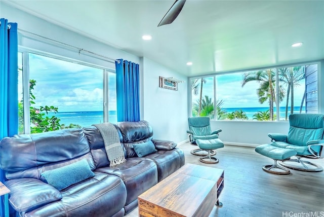 living room featuring a water view, ceiling fan, and hardwood / wood-style flooring