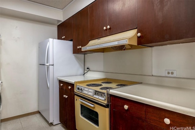 kitchen with electric range and white refrigerator