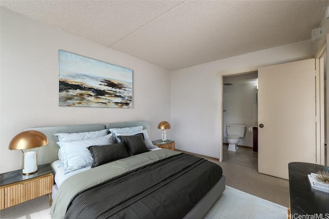 bedroom with a textured ceiling and ensuite bathroom