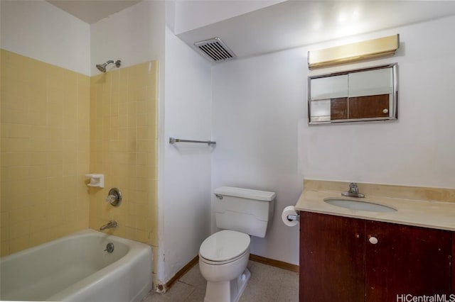 full bathroom featuring tiled shower / bath, vanity, and toilet