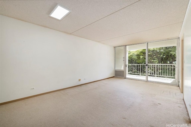 empty room with carpet floors and a textured ceiling