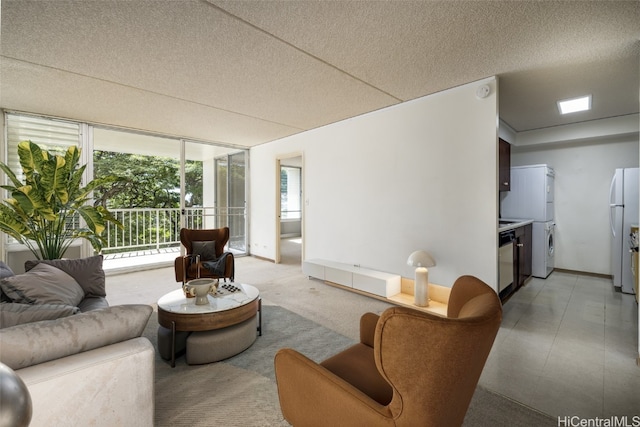 living room featuring a textured ceiling and a wall of windows