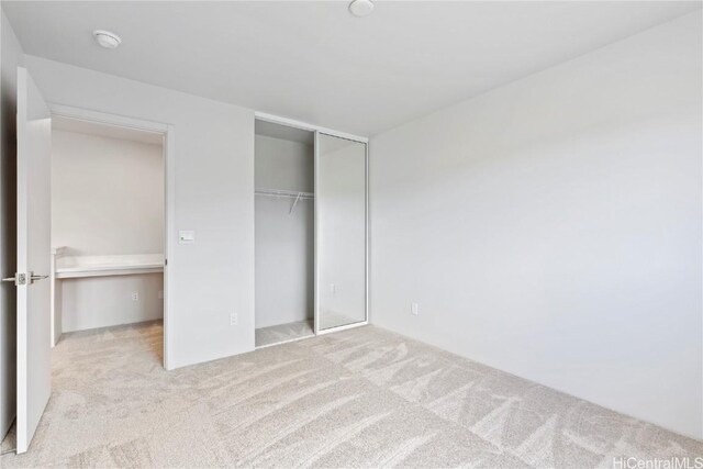 unfurnished bedroom with carpet floors and a closet