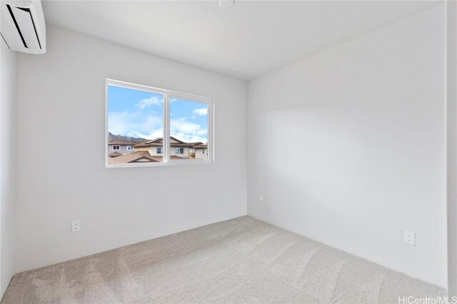 spare room with carpet and a wall unit AC