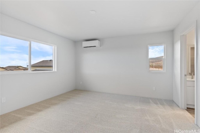 unfurnished room featuring carpet floors, a healthy amount of sunlight, and a wall mounted AC