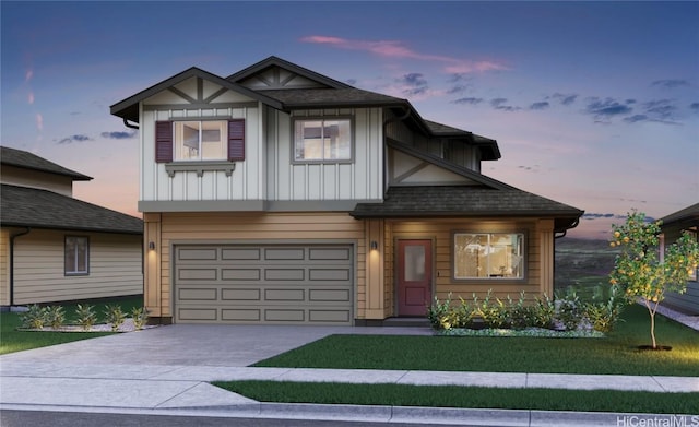 view of front of home with board and batten siding, concrete driveway, a lawn, and a garage