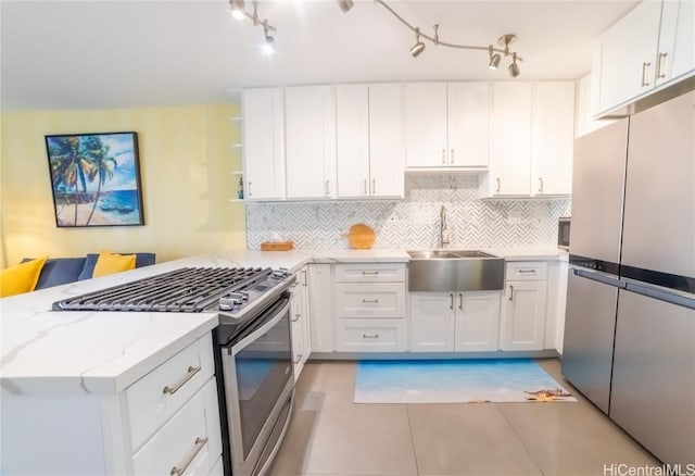 kitchen with stainless steel appliances, sink, and white cabinets