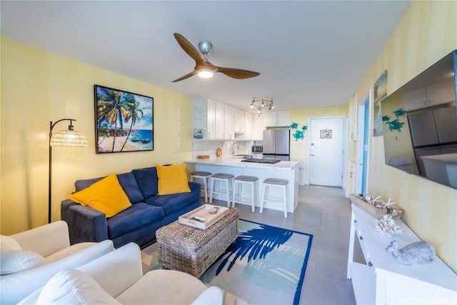 living room with sink, rail lighting, and ceiling fan