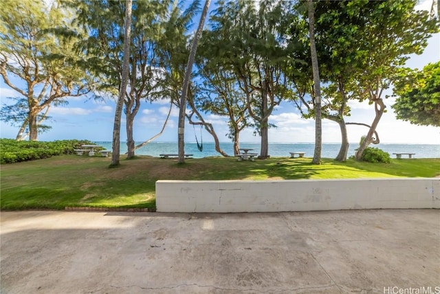 view of community featuring a water view and a yard