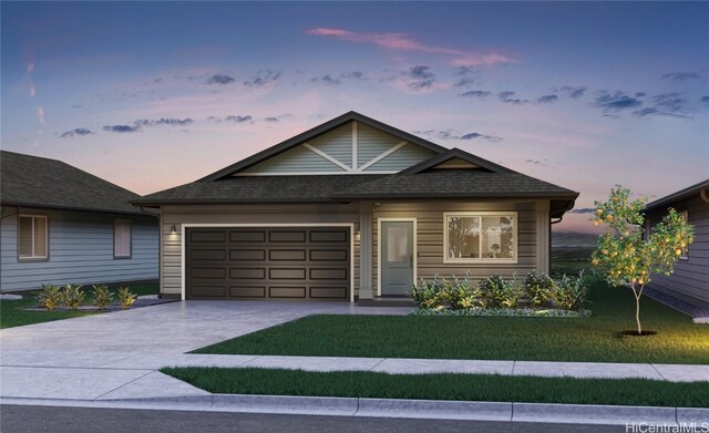 view of front of house with a garage and a lawn