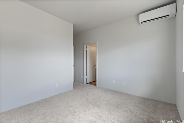 carpeted spare room with a wall mounted air conditioner