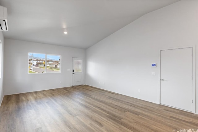 empty room featuring lofted ceiling and light wood-type flooring