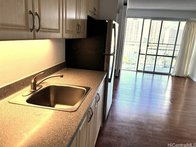 kitchen featuring sink, dark hardwood / wood-style floors, and stainless steel fridge