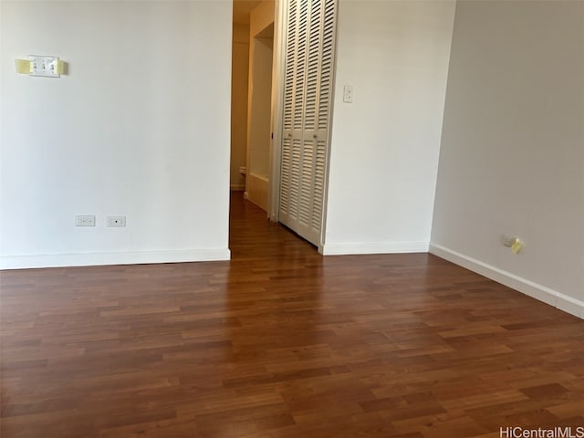 spare room featuring dark wood-type flooring