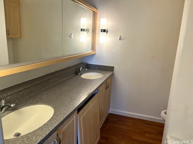 bathroom with vanity, toilet, and wood-type flooring