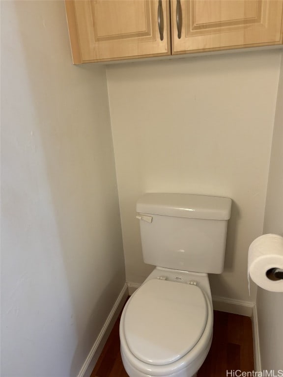 bathroom featuring hardwood / wood-style flooring and toilet