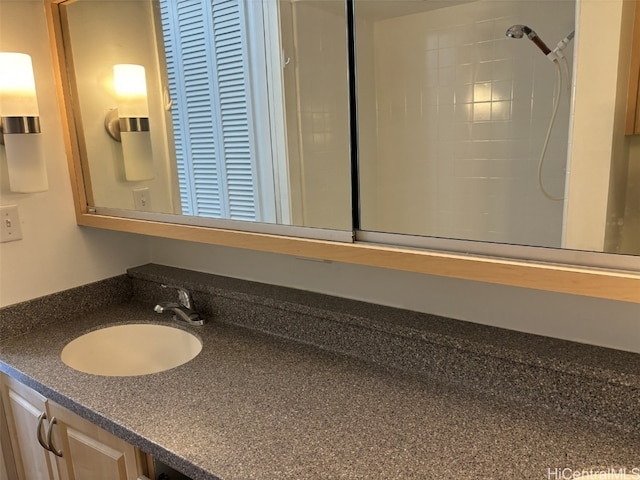 bathroom with vanity and a shower