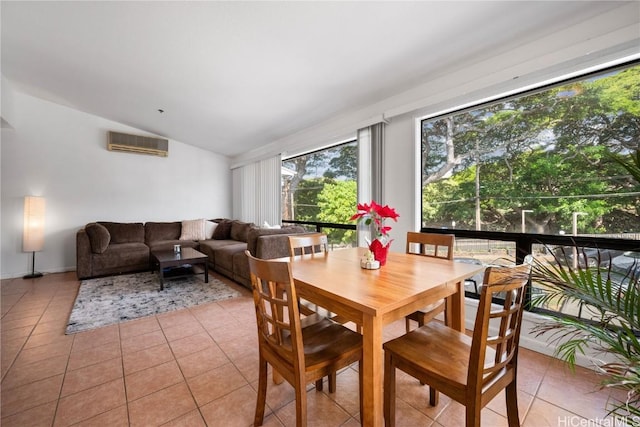 dining room with lofted ceiling, light tile patterned floors, and an AC wall unit