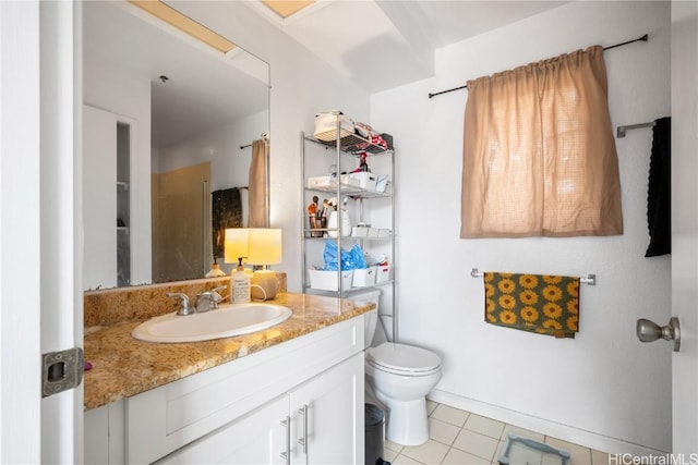 bathroom featuring vanity, tile patterned floors, and toilet