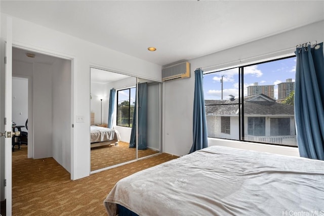 carpeted bedroom featuring a wall mounted air conditioner and a closet