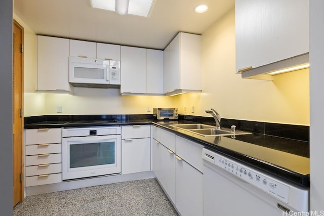 kitchen featuring sink, white appliances, and white cabinets