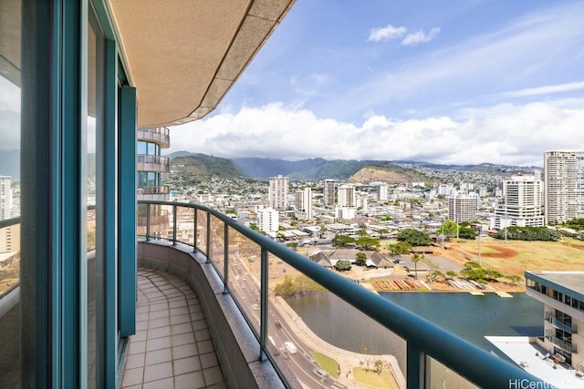 balcony featuring a water and mountain view