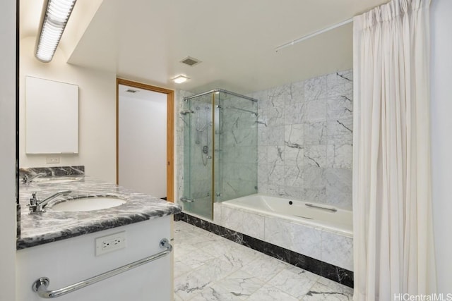 bathroom featuring vanity and shower with separate bathtub