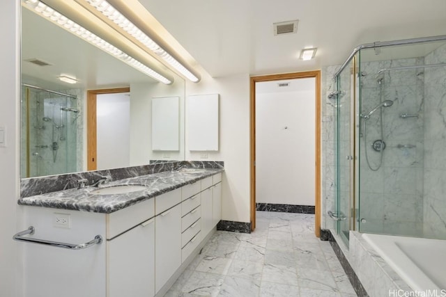 bathroom with vanity and shower with separate bathtub