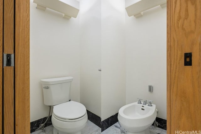 bathroom with a bidet and toilet