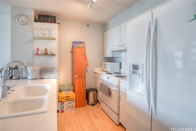 kitchen with white appliances, white cabinets, a textured ceiling, sink, and light hardwood / wood-style flooring