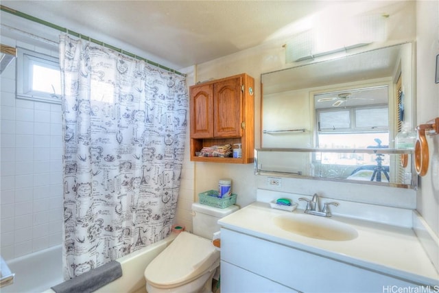 full bathroom featuring toilet, vanity, and shower / tub combo