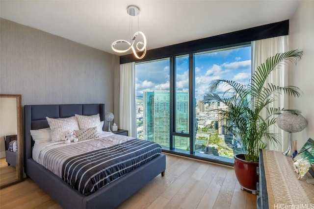 bedroom featuring light hardwood / wood-style floors and an inviting chandelier