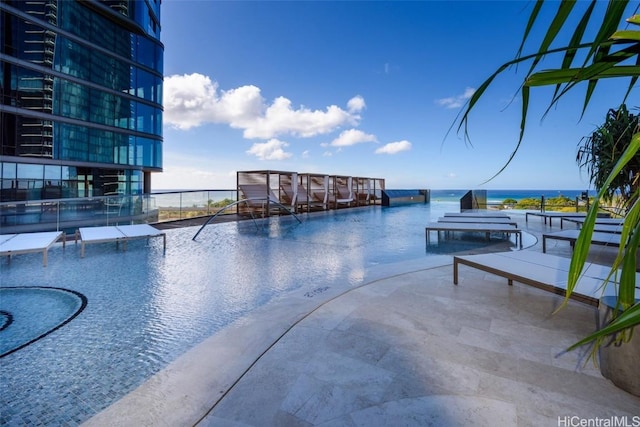 view of swimming pool featuring a water view