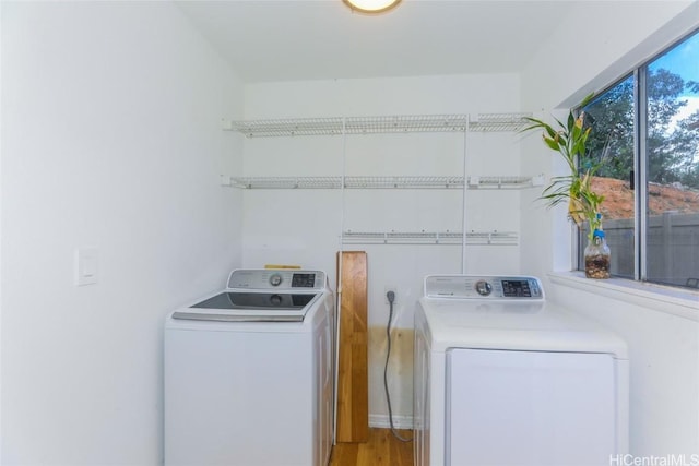 laundry area featuring independent washer and dryer and light wood-type flooring