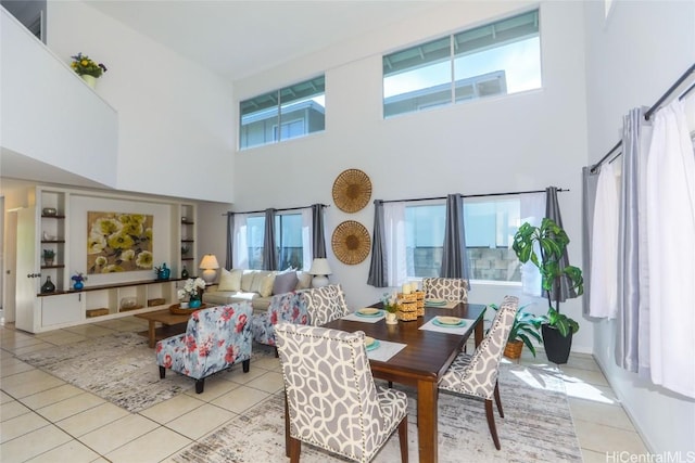 tiled dining space with a wealth of natural light and a towering ceiling