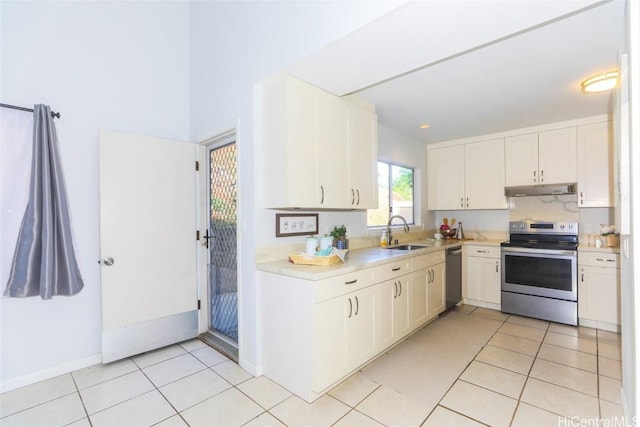 kitchen featuring light tile patterned floors, sink, white cabinetry, and appliances with stainless steel finishes