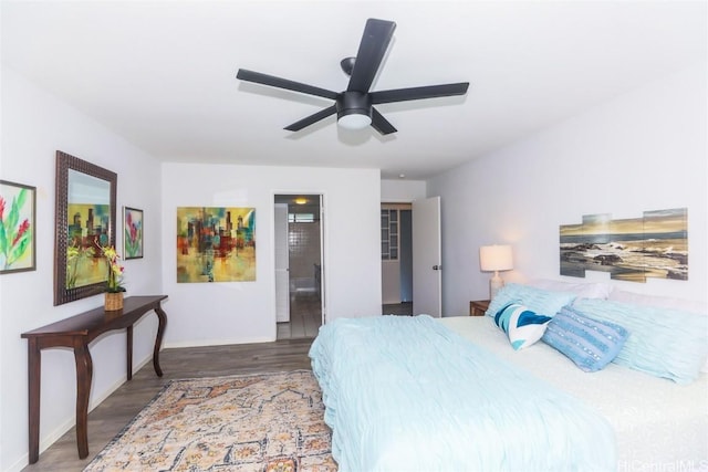 bedroom featuring ceiling fan, connected bathroom, and dark hardwood / wood-style flooring