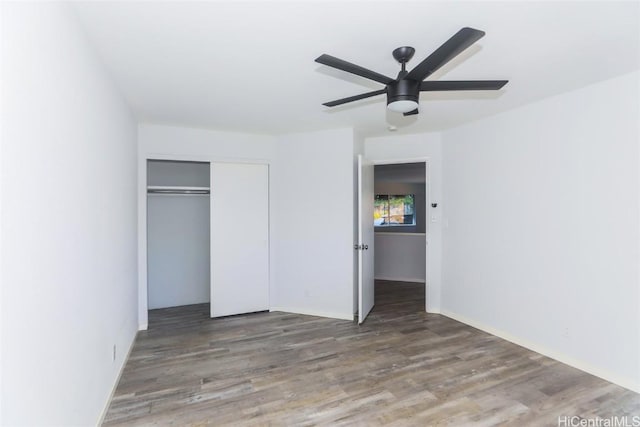 unfurnished bedroom with a closet, ceiling fan, and hardwood / wood-style floors