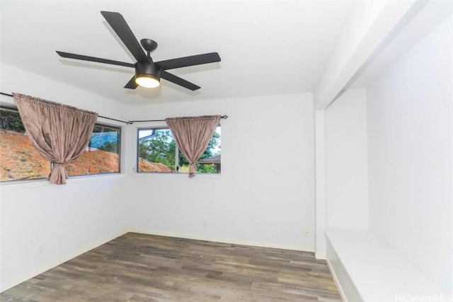 empty room featuring ceiling fan and dark hardwood / wood-style floors